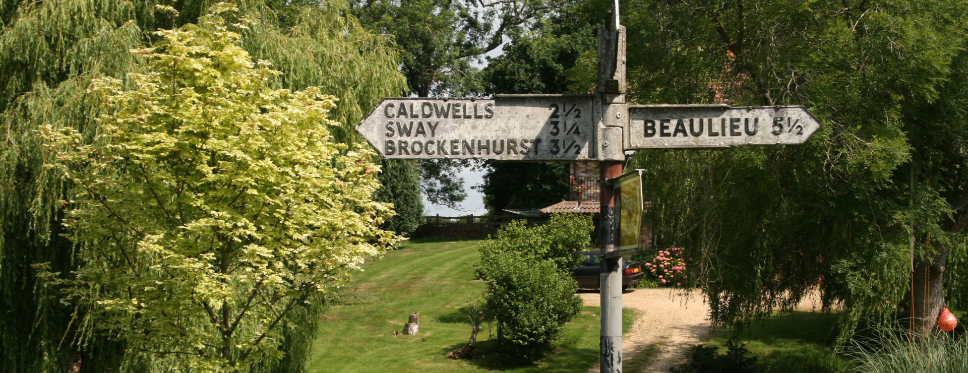 Photo of an old-style street sign with the distance to nearby villages